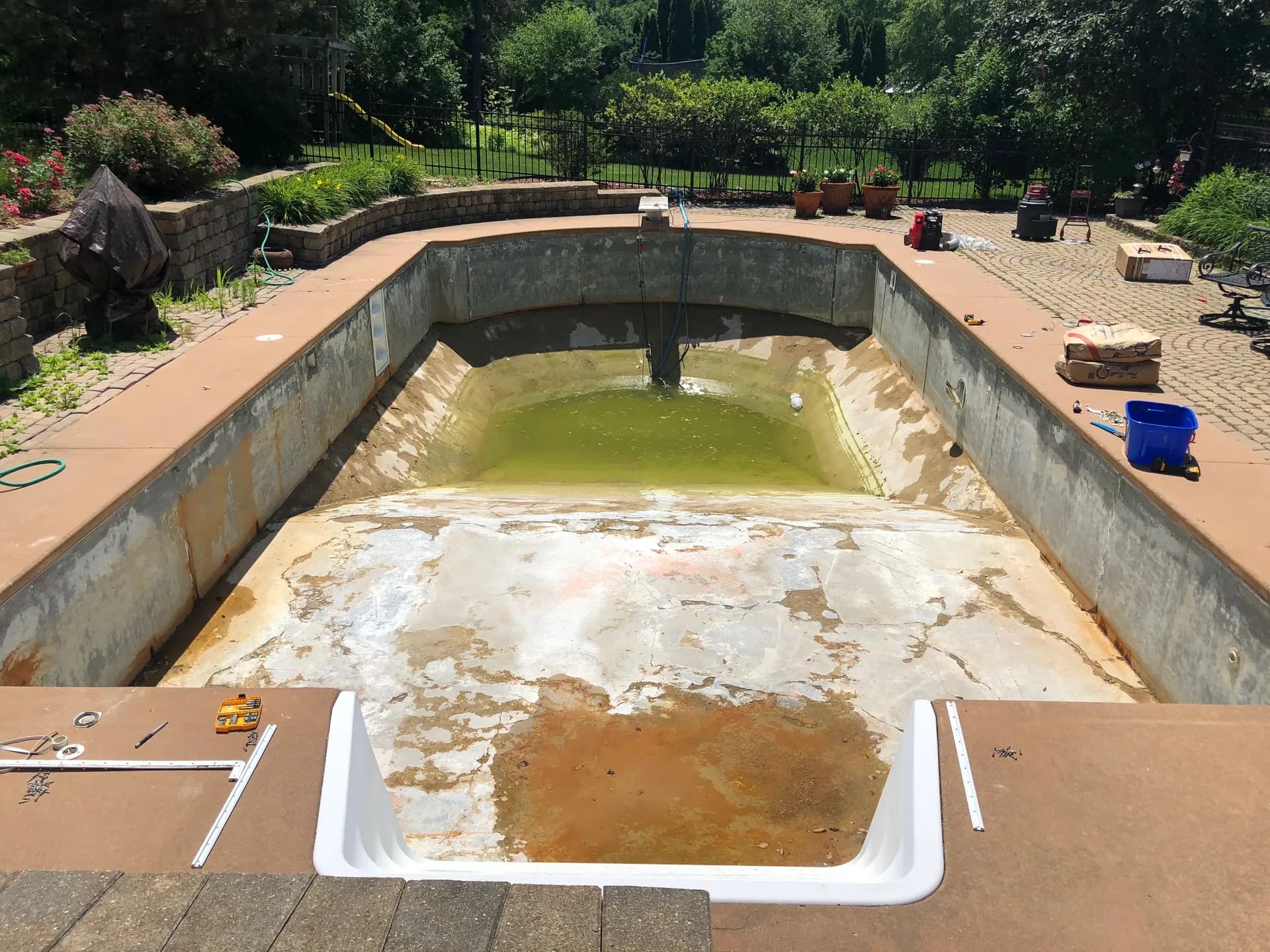 In-ground pool under construction with the shell and plumbing exposed